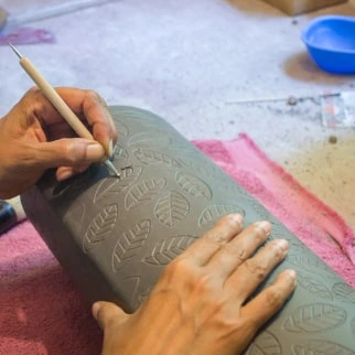 carving leaf on leather hard clay